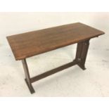 ARTS AND CRAFTS OAK HALL TABLE with an oblong top, standing on shaped end supports with carved tulip