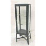 DARK GREEN METAL DISPLAY CABINET with glass sides and door opening to reveal adjustable shelves,
