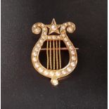 SEED PEARL SET LYRE SHAPED BROOCH in eighteen carat gold, 2.7cm high and approximately 3.2 grams