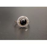 ATTRACTIVE ONYX AND DIAMOND DRESS RING the central round cabochon onyx in multi diamond surround