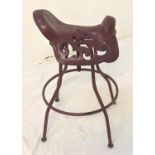 METAL SADDLE SEAT with pierced decoration and swivel action, standing on four shaped supports united