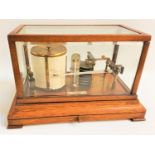 DOBBIE MCINNES LTD OF GLASGOW BARAGRAPH in an oak and glass case with a drawer below, 35.5cm wide