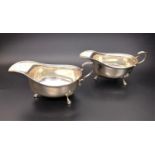 PAIR OF GEORGE V SILVER SAUCE BOATS both with beaded rims, shaped handles and raised on three pad