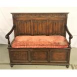 CARVED OAK HALL BENCH in the 18th century style, the raised back with a scroll carved frieze flanked