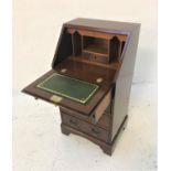 MAHOGANY AND CROSSBANDED BUREAU the fall flap with a green leather insert and a fitted interior,