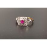 ART DECO STYLE RUBY AND DIAMOND CLUSTER RING the central round brilliant cut ruby approximately 0.