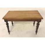 EDWARDIAN OAK KITCHEN TABLE with a rectangular moulded top, standing on turned tapering supports