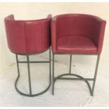 PAIR OF TUB BAR STOOLS with pink interior vinyl covering, raised on steel supports with shaped base,