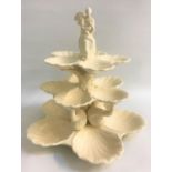 ROYAL CREAMWARE SHELLFISH STAND with a seated lady finial above three graduated tiers, each with