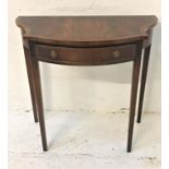 MAHOGANY AND CROSSBANDED SIDE TABLE with a shaped top above a frieze drawer, standing on tapering