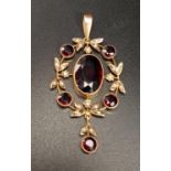ATTRACTIVE EDWARDIAN GARNET AD SEED PEARL PENDANT the central oval cut garnet in round garnet and