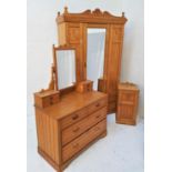 EDWARDIAN LIGHT OAK BEDROOM SUITE comprising a wardrobe with an arched carved pediment above a