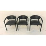 SET OF THREE HOOP BACKED EBONISED CHAIRS with padded back and shaped seats, standing on tapering