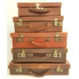 FIVE VINTAGE LEATHER BREIFCASES of varying sizes, all with leather handles, one marked 'M.B.',