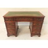 YEW WOOD SERPENTINE PEDESTAL DESK with an inset green leather top above an arrangement of nine