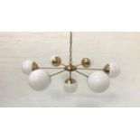 SIX BRANCH PENDANT LIGHT with opaque circular glass shades and brass effect suspension chain, and