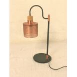 SHAPED TABLE LAMP raise on a circular anodized base with a pierced copper shade, 58cm high