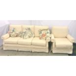 THREE SEAT SOFA AND ARMCHAIR all with loose seat and back cushions and scroll arms, on castors,
