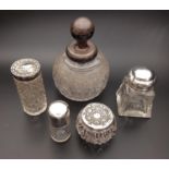 SELECTION OF SILVER TOPPED GLASS BOTTLES of various sizes and dates, including one with cherub