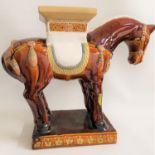 POTTERY GARDEN SEAT in the form of a horse, with decorative detail, raised on a plinth base, 49.