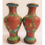 PAIR OF CLOISONNE BALUSTER VASES with a terracotta ground and floral motifs, 26.5cm high, together