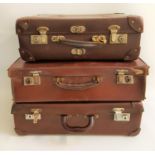 THREE VINTAGE LEATHER SUITCASES each with carrying handles and working locks (3)