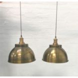 PAIR OF ANTIQUE BRASS EFFECT INDUSTRIAL PENDANT LIGHTS with domed shades and interior textured