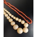 GRADUATED IVORY BEAD NECKLACE 49cmlong; together with a coral bead necklace, 55cm long (2)