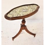 19TH CENTURY MAHOGANY OCCASIONAL TABLE with a shaped floral needlework top under glass, on a