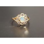 PRETTY OPAL AND DIAMOND CLUSTER RING the central round opal in eight diamond surround totaling