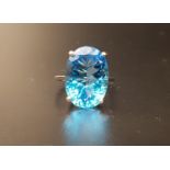 LARGE BLUE GEM SET COCKTAIL RING the large oval cut gemstone measuring approximately 17mm x 12.5mm x