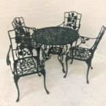 CAST ALUMINIUM GARDEN TABLE AND FOUR CHAIRS the table with a circular pierced top decorated with