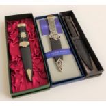 THREE MODERN BOXED SGIAN DUBH two with pewter mounts and one with a faux horn carved grip, all boxed