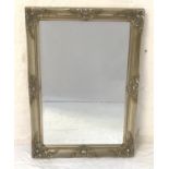RECTANGULAR WALL MIRROR with decorative silvered frame and beveled plate, 63cm high