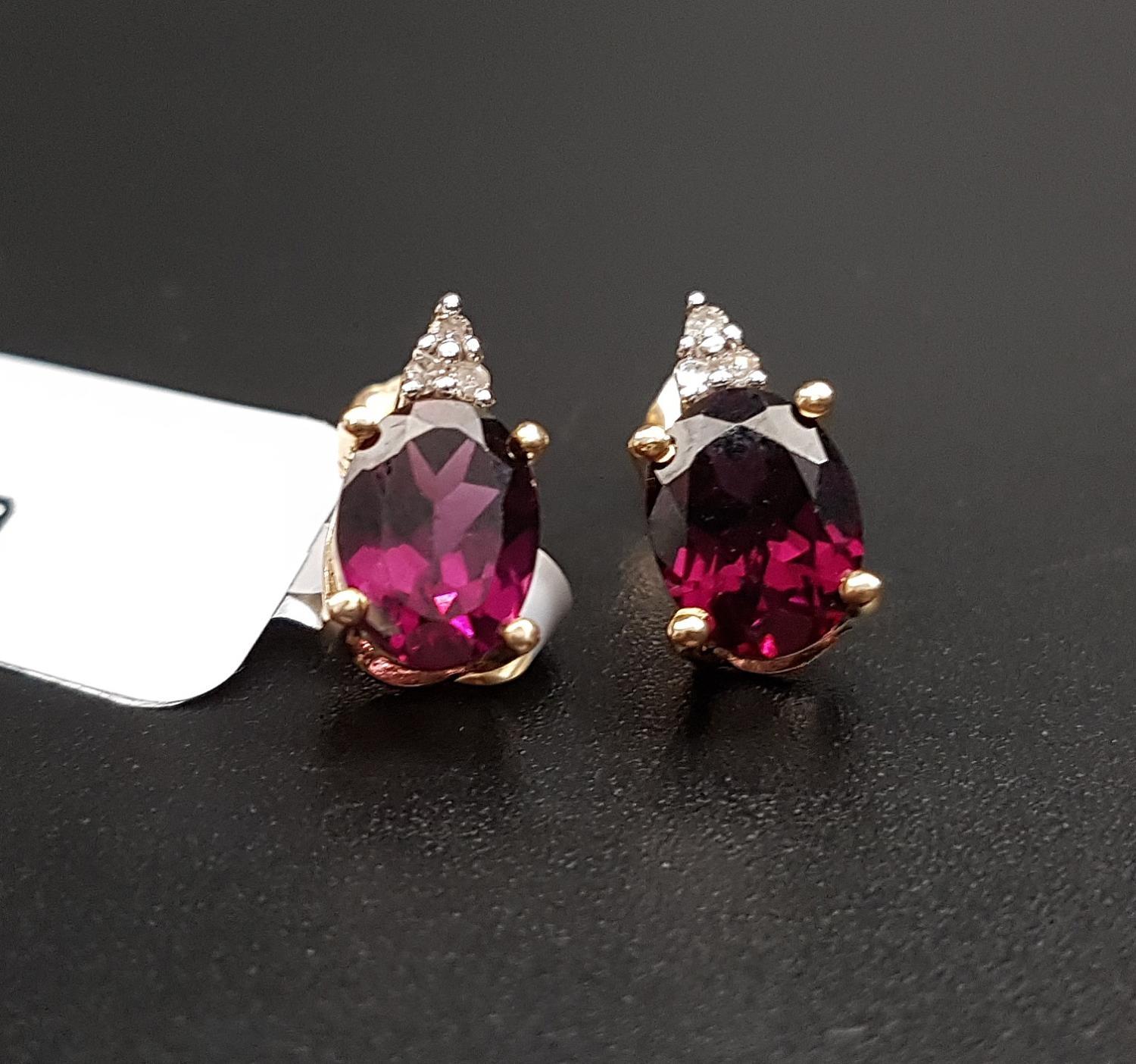 PAIR OF CERTIFIED GARNET AND DIAMOND EARRINGS each with an oval cut Rajasthan garnet below three