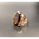 SMOKEY QUARTZ SINGLE STONE RING the oval cut quartz in unusual pierced setting, on nine carat gold