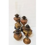 SELECTION OF COPPER AND BRASS EDWARDIAN AND LATER OIL LAMP BASES some with decorative reservoirs,