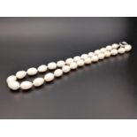 WHITE FRESHWATER BAROQUE PEARL NECKLACE the individually knotted pearls of ovoid shape,