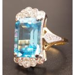 IMPRESSIVE BLUE TOPAZ AND DIAMOND COCKTAIL RING the large emerald cut blue topaz measuring