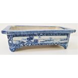 CHINESE PORCELAIN OBLONG PLANTER with canted corners and decorated with blue and white panels