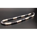 BLACK AND WHITE FRESHWATER PEARL NECKLACE with alternating sections of black and white pearls,
