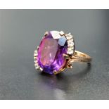 UNUSUAL PURPLE AND CLEAR GEM SET DRESS RING the central oval cut stone possibly alexandrite