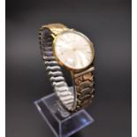 GIRARD-PERREGAUX GOLD PLATED WRIST WATCH the circular silvered dial with baton markers, the case