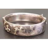 VICTORIAN STYLE SILVER BANGLE with engraved scroll decoration and safety chain, London hallmarks for