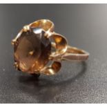 SMOKEY QUARTZ SINGLE STONE RING the circular quartz in pierced setting, on nine carat gold shank,