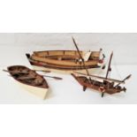 THREE MODEL BOATS comprising a rowing boat, a larger boat marked 'WARDI' and 'LAMU 1321'; and a