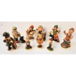 SELECTION OF FRIEDEL AND SIMILAR FIGURINES the five Friedel examples depicting a blacksmith, a boy