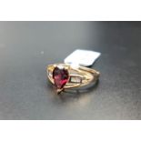 CERTIFIED GARNET AND DIAMOND RING the central pear cut Rajasthan garnet weighing 1.62cts, flanked by