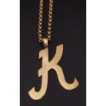 NINE CARAT GOLD 'K' PENDANT on nine carat gold belcher link chain, the chain 43cm long, total weight