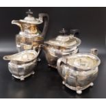 GEORGE V FOUR PIECE SILVER TEA SET of lobed form and all raised on flattened bun feet, comprising